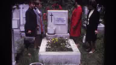 France (1967): Four Well Dressed Women Stand Around A White Stone Grave