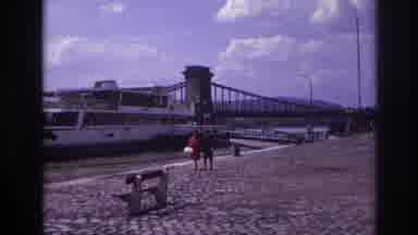 France (1967): Two Women Walking By A River With A Large Boat Beside Them