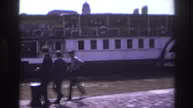 France (1967): Three Men Walking Away From A Floating Ocean Liner Sitting On The