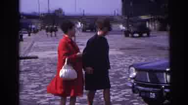 France (1967): Two Women Walking Towards Automobile Near Waterway