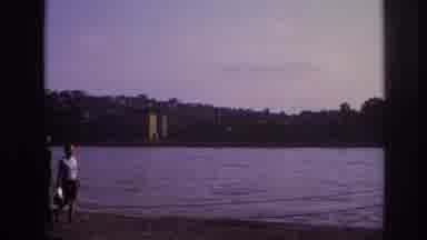 France (1967): Two People Walk Along The Water's Edge In The Late Afternoon