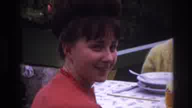 France (1967): Zoomed In On A Happy Girl's Face, Then Pans Out To Show A Table