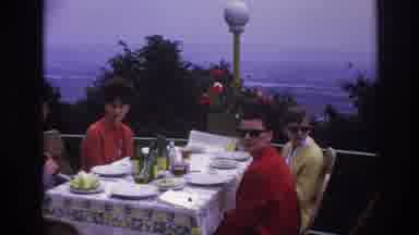France (1967): Four Adults Eating On A Balcony Overlooking A Blue View