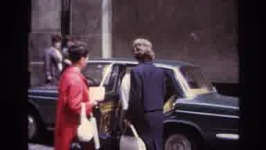 France (1967): Two Individuals Stepping Into A Car While A Third Stands Behind