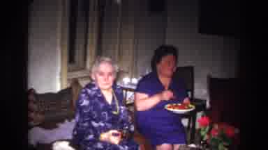 France (1967): Two Women Eating On A Couch, One Laughs