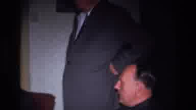 France (1967): Zoom Shot Of Three Men At A Black Suit Style Event