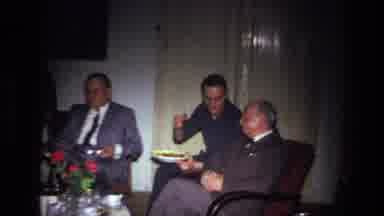 France (1967): Men Gather In Social Setting While Enjoying Food And Smoking