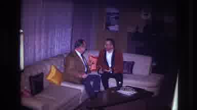 Ottawa Canada (1967): Two Men Sitting On The Couch Talking While A Woman In A Red
