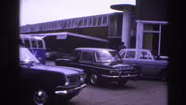 Paris France (1967): Car Slowly Driving Through The Parking Lot Of A Large Motel