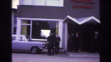 Paris France (1967): Men Dressed Up Standing And Waiting Outside A Hotel Sign With