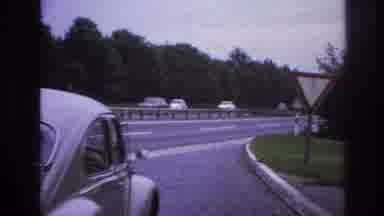 Paris France (1967): A Car Leaves A Neighborhood To Merge Onto The Highway
