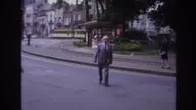 Paris France (1967): An Older Balding Man In A Suit Crossing The Street While A