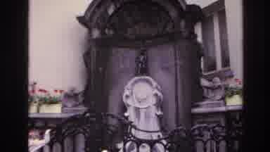 Paris France (1967): A Statue Behind An Ornate Fence Being Examined By A Family Of