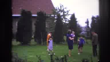 Paris France (1967): Three Adults And Four Children Walking In A Yard Surrounded