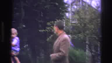 Paris France (1967): Man Smokes Cigarette Near Family Taking Video Outdoors In