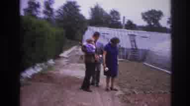Paris France (1967): Woman And Two Men And A Baby Look At Plants Outside Of
