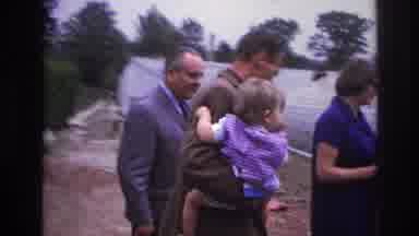 Paris France (1967): A Man Holding A Baby Walks With Another Man While They Talk