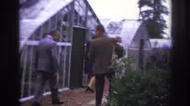 Paris France (1967): Man Holding Child As He Surveys A Greenhouse And Surrounding