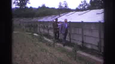 Paris France (1967): Two Men Walk Next To A Small Garden In A Yard