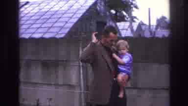 Paris France (1967): Father Holding Baby While Talking To Man In Business Suit In