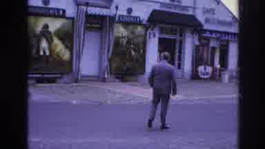 Paris France (1967): A Man Crossing The Road Before A Scooter Driver Passes By