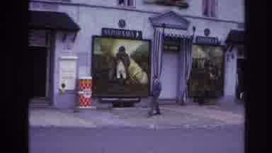 Paris France (1967): Man Walking On Sidewalk While Looking At Pictures With Hands