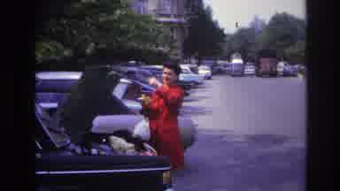 Paris France (1967): Lady In Red Coat With Boot Opened Pointing To The Sky
