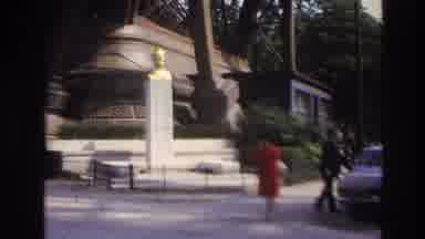 Paris France (1967): A Couple Stands Outside In A Park Looking At A Large Statue