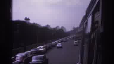 Paris France (1967): Cars Driving Down A One-Way Street On A Tree Lined Street In