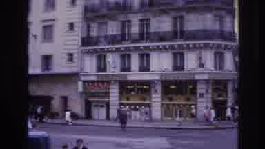 Paris France (1967): People Walking And Cars Driving Busy City With Tall Buildings