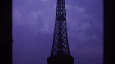 Paris France (1967): Panning View Of Iron Tower Across Backdrop Of Grey Cloudy Sky