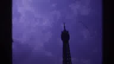 Paris France (1967): The Top Of A Tower Shown Against A Dark, Cloudy Sky