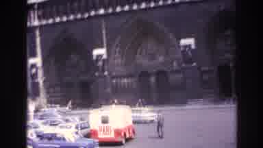 Paris France (1967): A Man Walks Through The Parking Lot Of An Historical Building