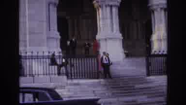 Paris France (1967): A Woman In A Red Coat Leans Against A Large White Column Of A