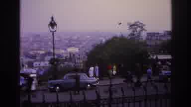 Paris France (1967): Many People Walking On A Sidewalk That Overlooks A Large City