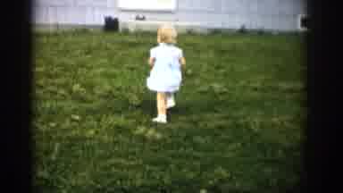Colorado USA (1959): A Young Happy Blonde Baby Girl In A Blue Dress, Wobbly