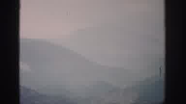 Colorado USA (1959): Fog Covers A Deep Ravine Between Two Tree-Covered Mountains