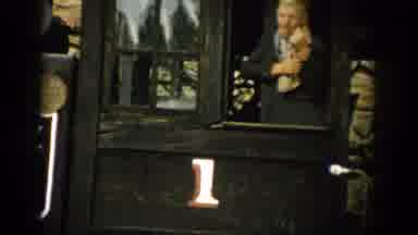 Colorado USA (1959): Man Standing Wiping Face In Window With Number One On Outside