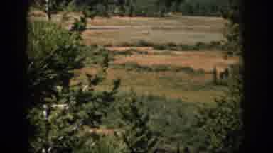 Colorado USA (1959): Car Driving Down A Country Road Beneath A Mountain