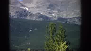 Colorado USA (1959): Mountains Against Forest Then Close Up Of Chipmunk Eating Out