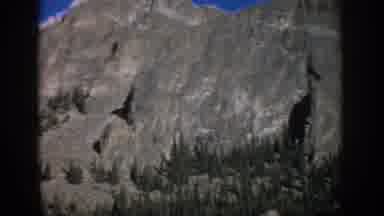 Colorado USA (1959): Rocky Cliff Face With Trees And Blue Skies In National Park