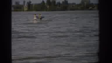 Colorado USA (1959): Woman Water Skiing Behind Motor Boat On Lake During A Windy