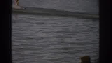 Colorado USA (1959): A Kayak Skimming Across A Large Body Of Water And A Cut Away