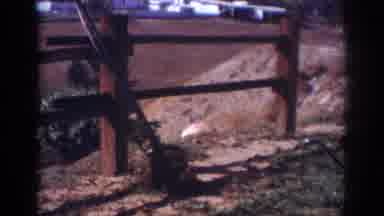 Blainsport Pennsylvania USA-1962: Man Working Outside Near Wooden Fence