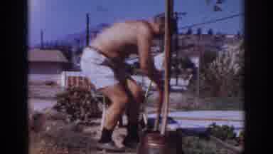 Blainsport Pennsylvania USA (1962): A Shirtless Man Digging A Hole And Fixing A