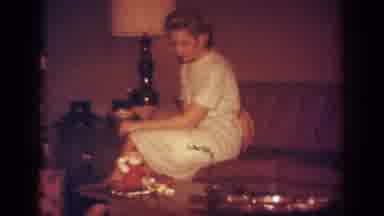 Blainsport Pennsylvania USA (1962): Woman Opens Christmas Presents Under Tree