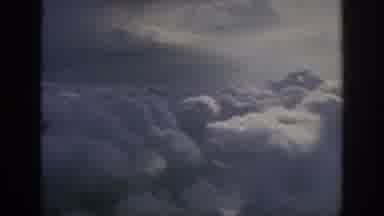 Anaheim California USA (1962): An Propeller-Powered Aircraft Flies Above Billowing