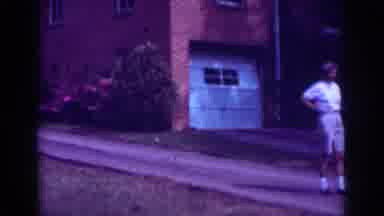 Raleigh North Carolina USA (1962): Person Walks Down Driveway Of Brick House With