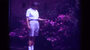 Raleigh North Carolina USA (1962): Person Standing Next To Flower Bushes Touching