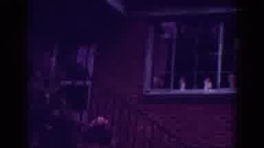 Raleigh North Carolina USA (1962): An Elderly Person Stands On A Porch With A